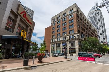 a city street with a tall building and a mcdonalds restaurant on the corner at 310 at Nulu Apartments-Student, Kentucky